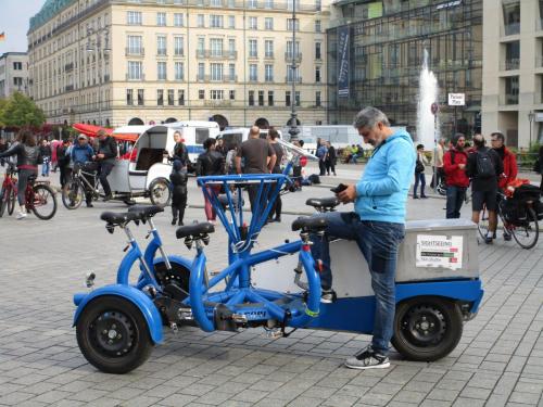 Weird bike thing operated by, like, 5-6 people.