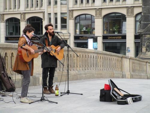 Street musicians. Yeah, I bought a couple CDs. They only had solo CDs for each of them. Trying to earn money to make their new group CD.